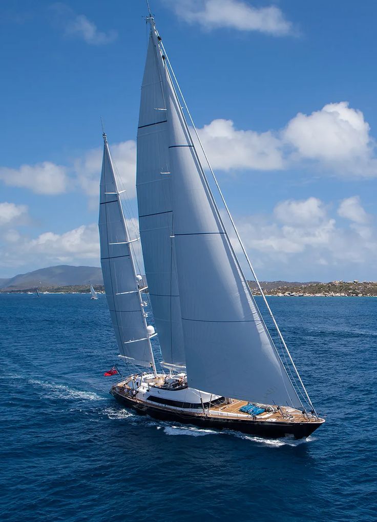 a sailboat sailing in the ocean on a sunny day