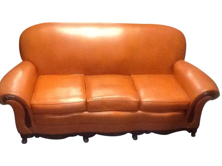 a brown leather couch sitting on top of a white floor