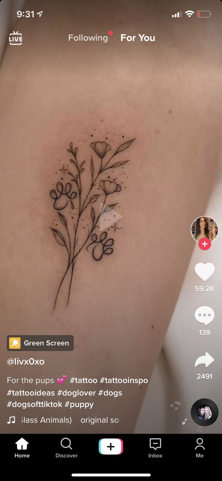 a small flower tattoo on the back of a woman's left shoulder and chest