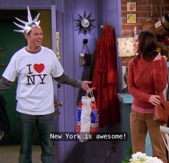 a man in a new york t - shirt is holding shopping bags and talking to a woman