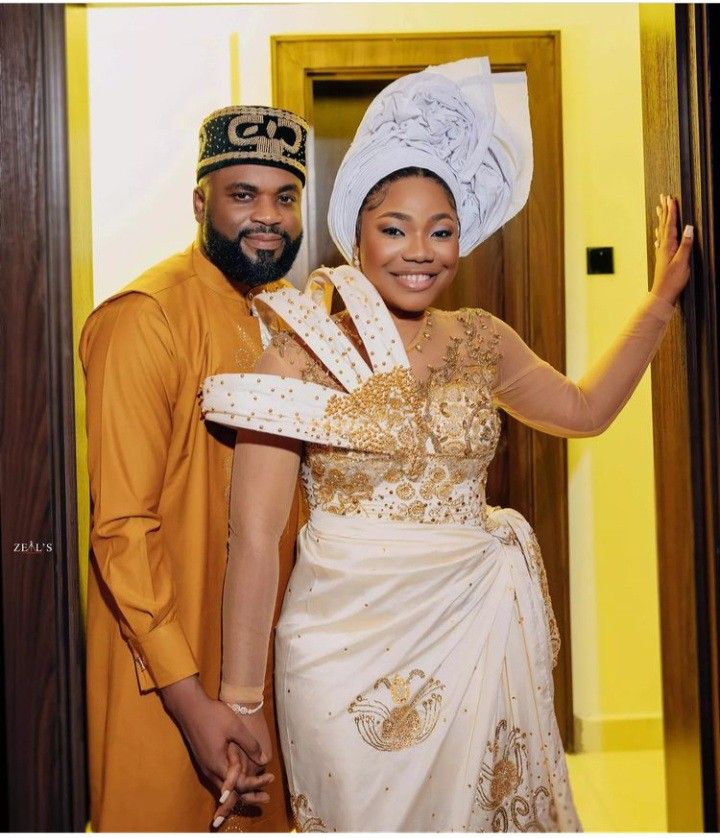 a man and woman dressed in traditional african attire