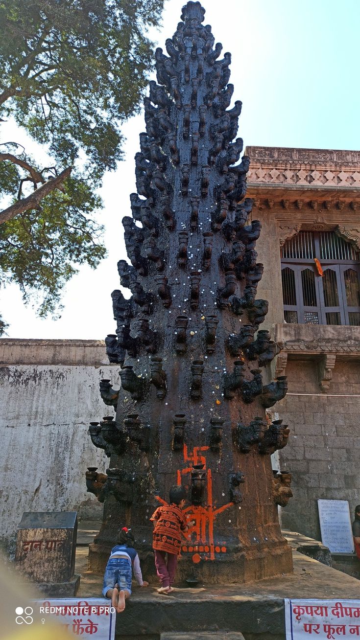 there is a large tree made out of bottles