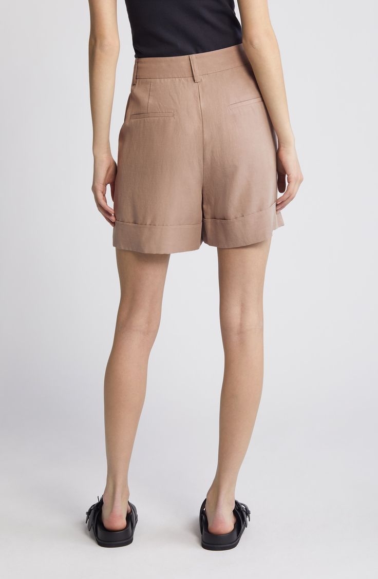 A wide-cuff adds style points to staple shorts made from a feel-good fabric that features airy linen and soft, sustainable Tencel® lyocell. 5 1/2" inseam; 24" leg opening; 12" front rise; 16" back rise (size 10 UK)   90% Tencel® lyocell, 10% linen   Dry clean   Imported Chic Relaxed Fit Bottoms With Rolled Hem, Beige Bottoms With Button Cuffs For Summer, Beige Bottoms With Button Cuffs For Spring, Spring Beige Bottoms With Button Cuffs, Linen Bottoms For Spring In Short Length, Linen Bottoms For Spring With Short Length, Spring Linen Bottoms In Short Length, Linen Spring Shorts, Chic Summer Shorts With Button Cuffs