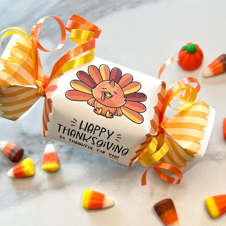 a candy bar wrapped in orange and yellow striped paper with an image of a turkey on it