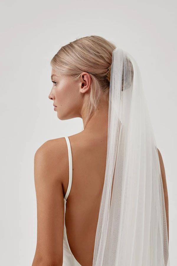 the back of a woman wearing a wedding veil