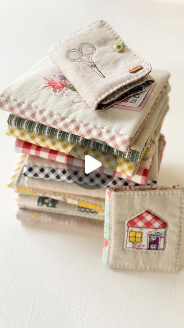 a stack of cloths sitting next to each other on top of a white table