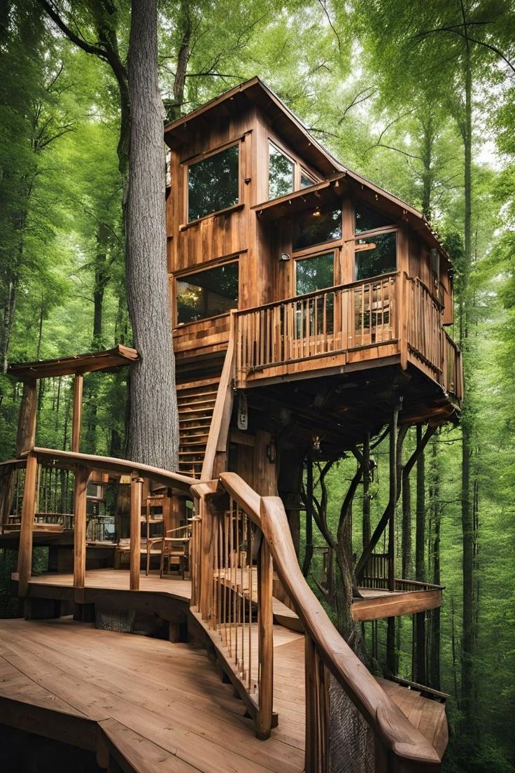 a wooden tree house in the middle of a forest with stairs leading up to it