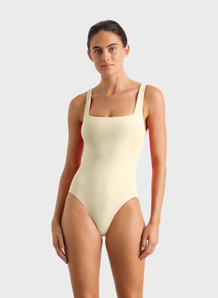 Margot one piece in Porcelain is a timeless classic swimsuit has an elegant square neckline front and back and invisible under-bust support. Self-lined in our ultra-soft Embodee™ fabric that has high shaping power, gently holding, shaping and enhancing the silhouette. To ensure the garment is opaque when wet, the front of the suit is a triple layer. A beautiful, classic one piece that will show off your summer tan and in a soft, matte fabric works perfectly as a body suit worn under skirts, shorts and pants. Luxury fabric sustainably made in Italy.Garment sustainably and ethically made in Australia. Classic Swimsuit, Summer Tan, Matte Fabric, Summer Tanning, Luxury Fabric, Designer Swimwear, Body Suit, Luxury Fabrics, Timeless Classic