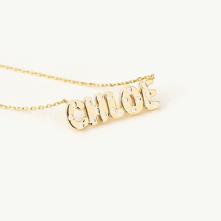 1- D E S C R I P T I O N Experience the epitome of elegance with our 14K Solid Gold Personalized Diamond Name Necklace. Impeccably designed, this dainty necklace features your name delicately crafted and adorned with brilliant flush-set diamonds. The diamond detailing and bubble font make it a fun and personal piece that reflects your individual style. Elevate your jewelry collection with this stunning necklace. 2- P R O D U C T ∙ F E A T U R E S * Gold material: 14K solid gold * Gold color opti Diamond Name Necklace, Flush Set Diamond, Bubble Necklaces, Solitaire Necklaces, 14k Gold Necklace, Name Jewelry, Handcrafted Necklace, Evil Eye Necklace, Engraved Necklace