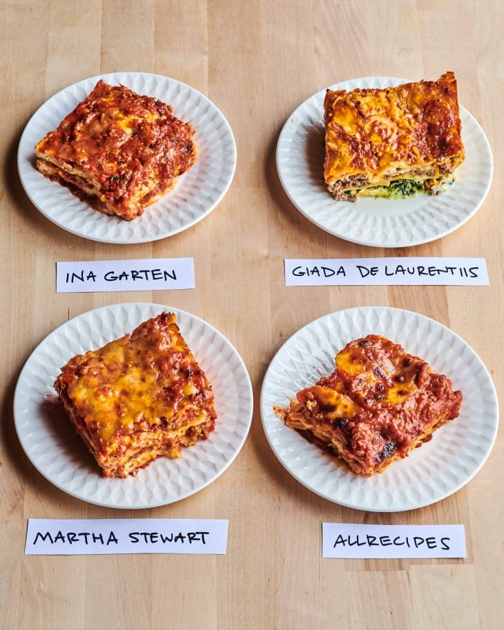 four plates with different types of lasagna sitting on top of a wooden table