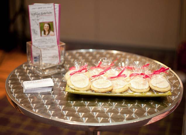 a tray that has some cookies on it with pink ribbon around the edge and another plate next to it