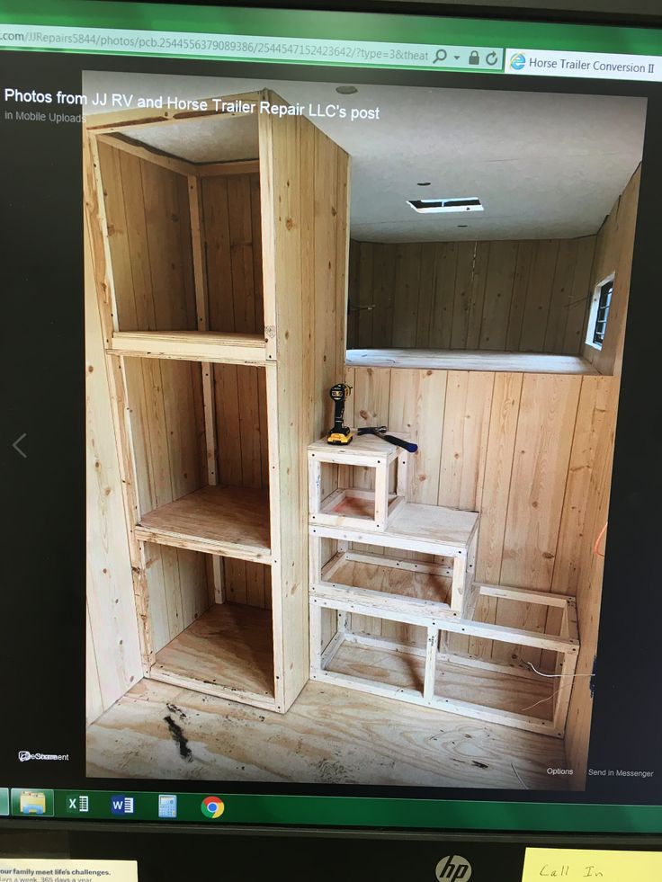 a computer screen showing the inside of a wooden room with shelves and tools on it