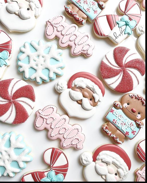 many decorated cookies are displayed on a white surface with snowflakes and candy canes