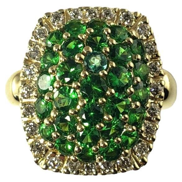 Vintage 14 Karat Yellow Gold Tsavorite Garnet and Diamond Ring Size 8 JAGi Certified- This lovely ring features 29 round tsavorite garnets and 24 round brilliant cut diamonds set in 14K yellow gold. Top of ring measures 19 mm x 17 mm. Shank: 3 mm. Total tsavorite weight: 2.90 ct. Total diamond weight: .35 ct. Diamond color: J-K Diamond clarity: VS2-SI1 Size: 11 mm x 9 mm Weight: 10.2 gr./ 6.5 dwt. Stamped: 14K JAGi Certificate included. Very good condition, professionally polished. Will come pac Garnet And Diamond Ring, Tsavorite Garnet, Gold Top, Lovely Ring, Round Brilliant Cut Diamond, Diamond Clarity, Cocktail Rings, Colored Diamonds, Garnet