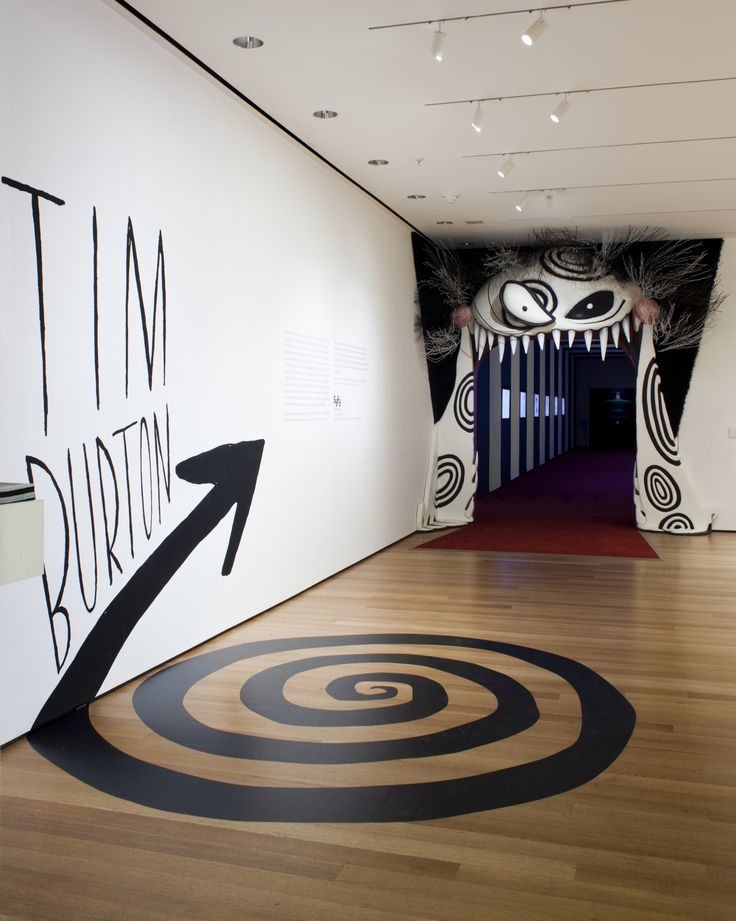 an art gallery with black and white artwork on the walls