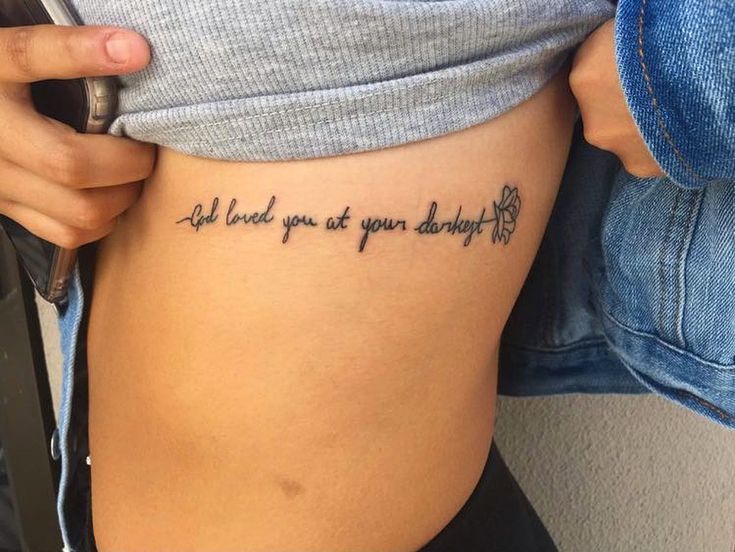 a woman with a tattoo on her stomach that says, all i need is you