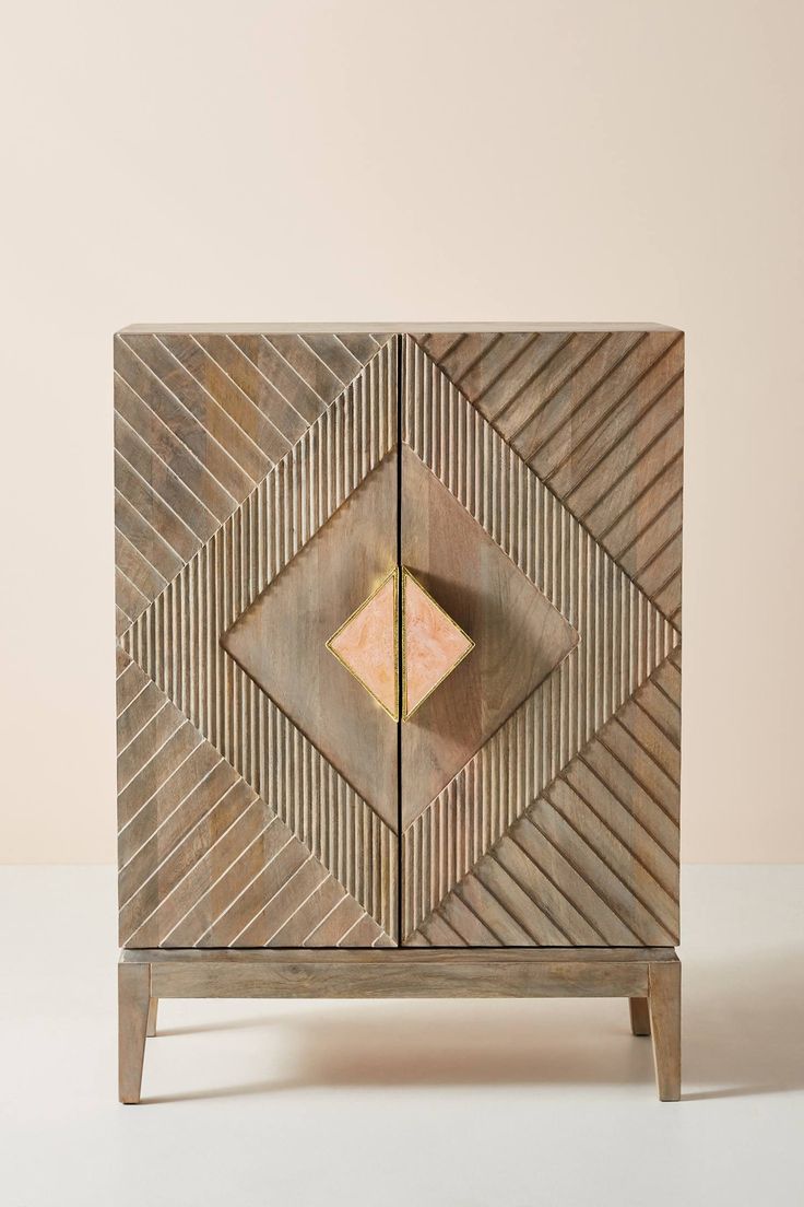 a wooden cabinet with geometric designs on it