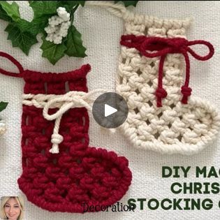 crocheted christmas stockings with red and white trims on them, next to flowers