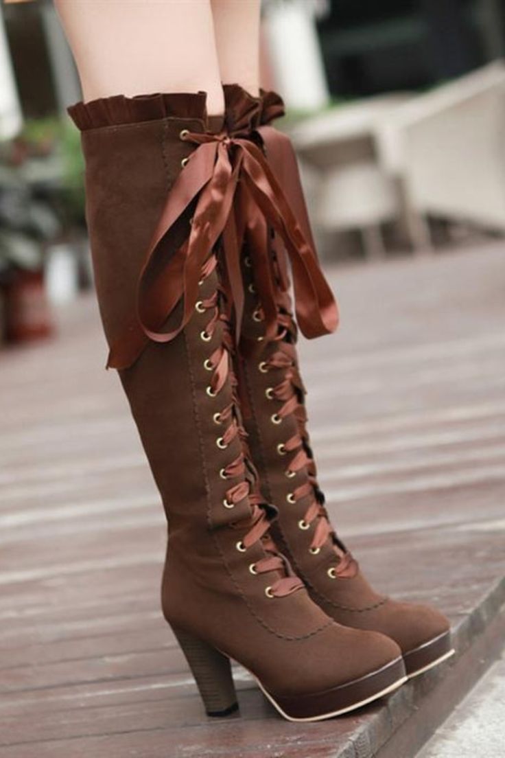 woman wearing brown steampunk boots Gothic Lace-up Knee-high Boots For Fall, Fitted Brown Lace-up Knee-high Boots, Vintage Lace-up Pointed Toe Boots For Fall, Vintage Pointed Toe Lace-up Boots For Fall, Gothic Fitted Knee-high Boots With Round Toe, Gothic Fitted Heeled Boots With Round Toe, Gothic Heeled Boots With Round Toe, Fitted Gothic Heeled Boots With Round Toe, Steampunk Round Toe Boots For Fall