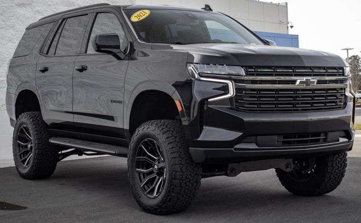 a silver truck parked in front of a building