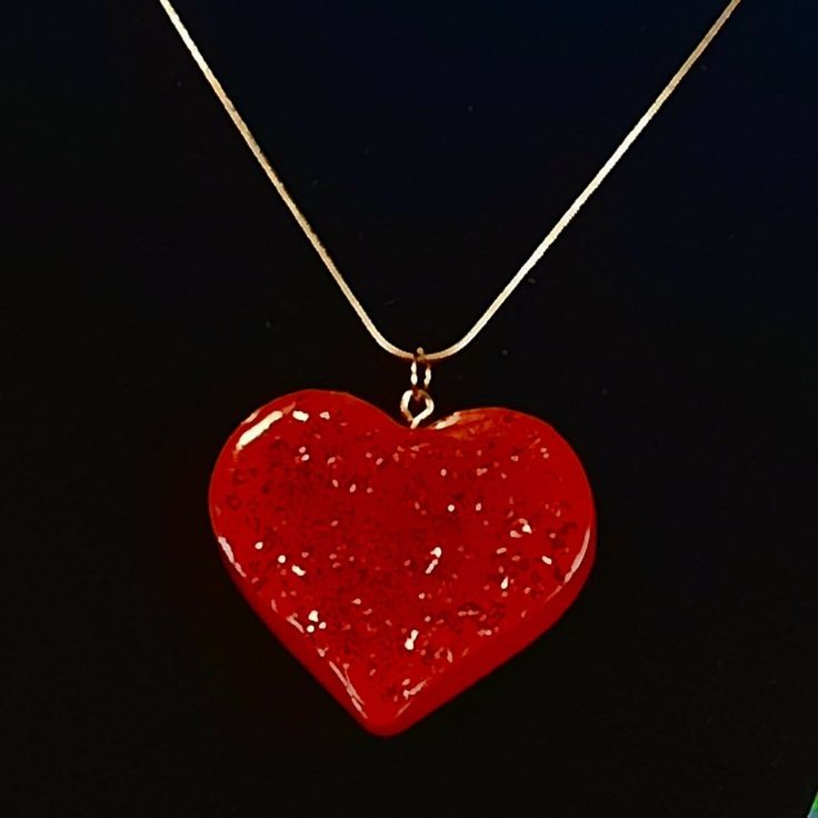 "This is a beautiful resin heart shaped pendant or it could be a charm or key chain....whatever your preference.  It is made from red resin with red glitter on the front of the heart.  On the back it says be mine.  This would be a great gift for Valentine's Day for your significant other.  It is 1-3/4\" X 1-1/4\".  It has a gold (plated) 20 Inch chain.  If you would rather have it as a key chain for your male partner, I can replace the necklace chain with a gold key ring, just let me know when you order it.  It will ship from Hixson, TN by 1st. class mail.  Thank you for shopping at Critters-R-Us :o)" Resin Heart Charm Pendant Jewelry, Resin Heart Charm Necklace Gift, Red Heart Pendant Necklace For Party, Heart Shaped Resin Jewelry For Party, Red Heart Charm Necklace For Gift, Red Heart Necklace For Gifts, Red Heart Necklace For Gift, Heart-shaped Resin Jewelry For Valentine's Day, Heart Shaped Resin Jewelry For Valentine's Day