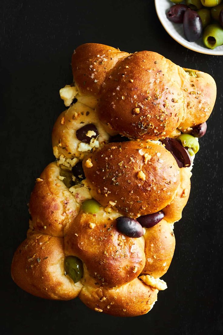 several rolls stacked on top of each other with olives