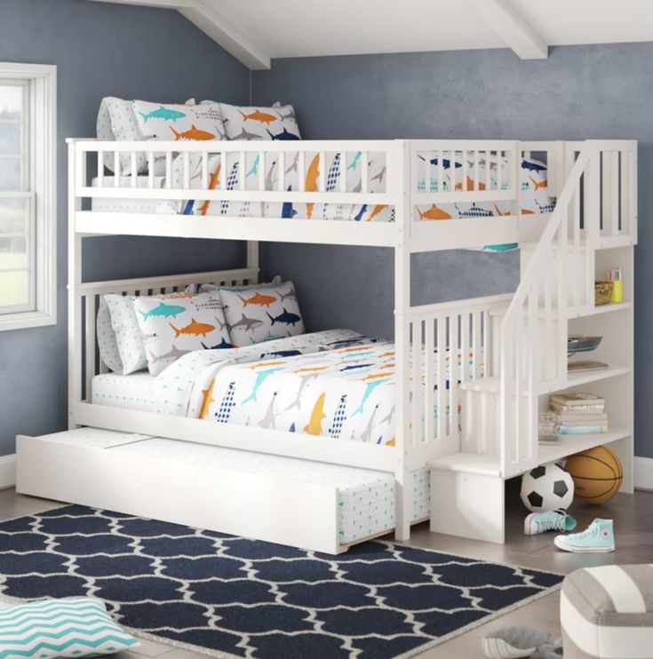 a child's bedroom with blue walls and white bunk beds in the corner, along with a soccer ball on the floor