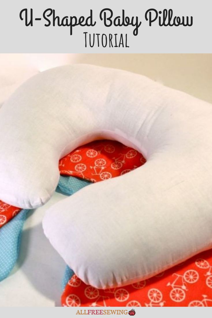 the neck pillow is on top of an orange and white cloth with a blue tie around it