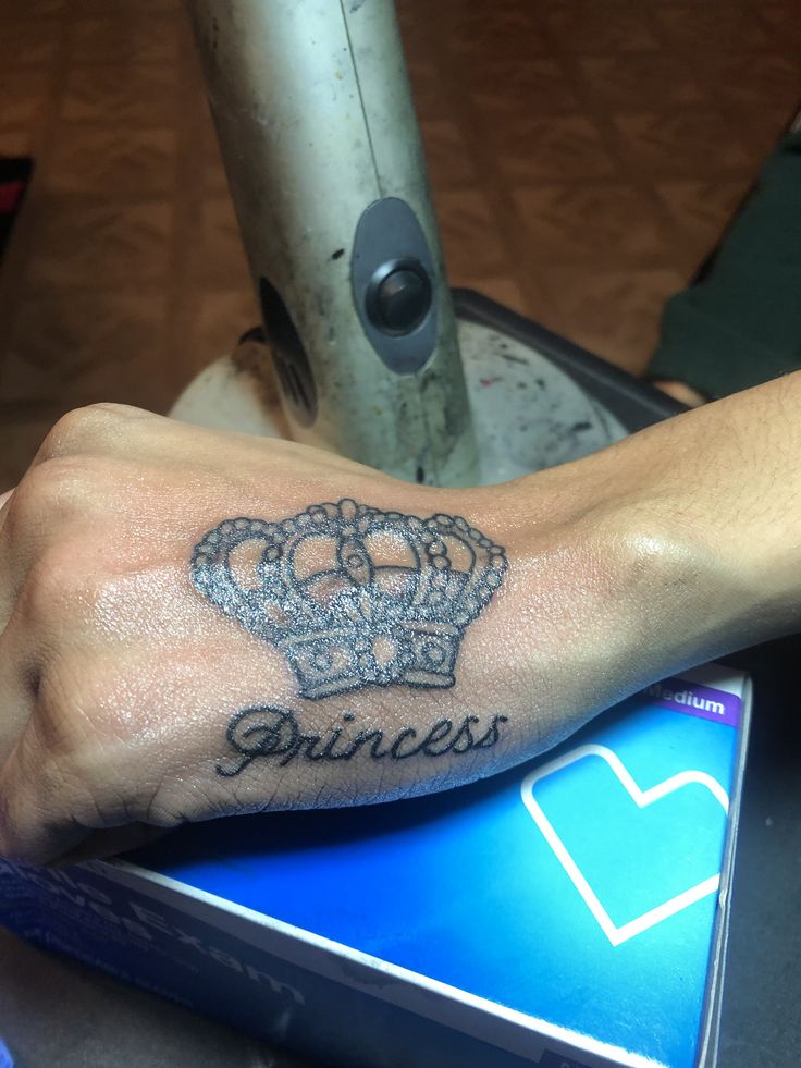 a person's arm with a tattoo on it and the word princess written in cursive font