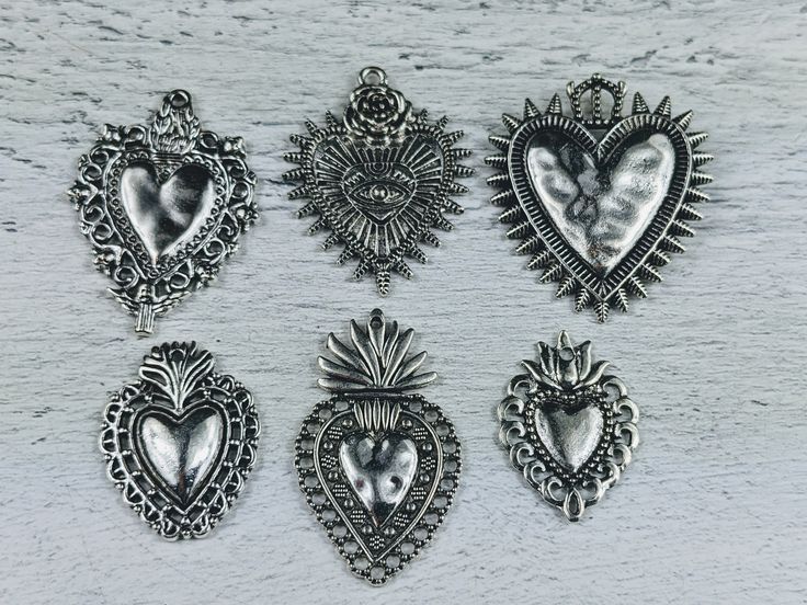 Listing is for 2 charms of chosen design made of a metal alloy with an antique silver finish great for bracelets and necklaces textured ornate design throughout 1mm hole on 4 of the charms...1.5mm hole on evil eye and large crown heart also available in store in a patina/oxidized finish 1 thorugh 6 starting from the left top row Silver Heart Metal Charms, Silver Heart Charms For Jewelry Making, Nickel Free Silver Heart Charms, Nickel-free Silver Heart Charms, Nickel-free Heart Silver Charms, Silver Metal Charms For Valentine's Day, Handmade Silver Heart Charms, Love Spiritual, Rose Love