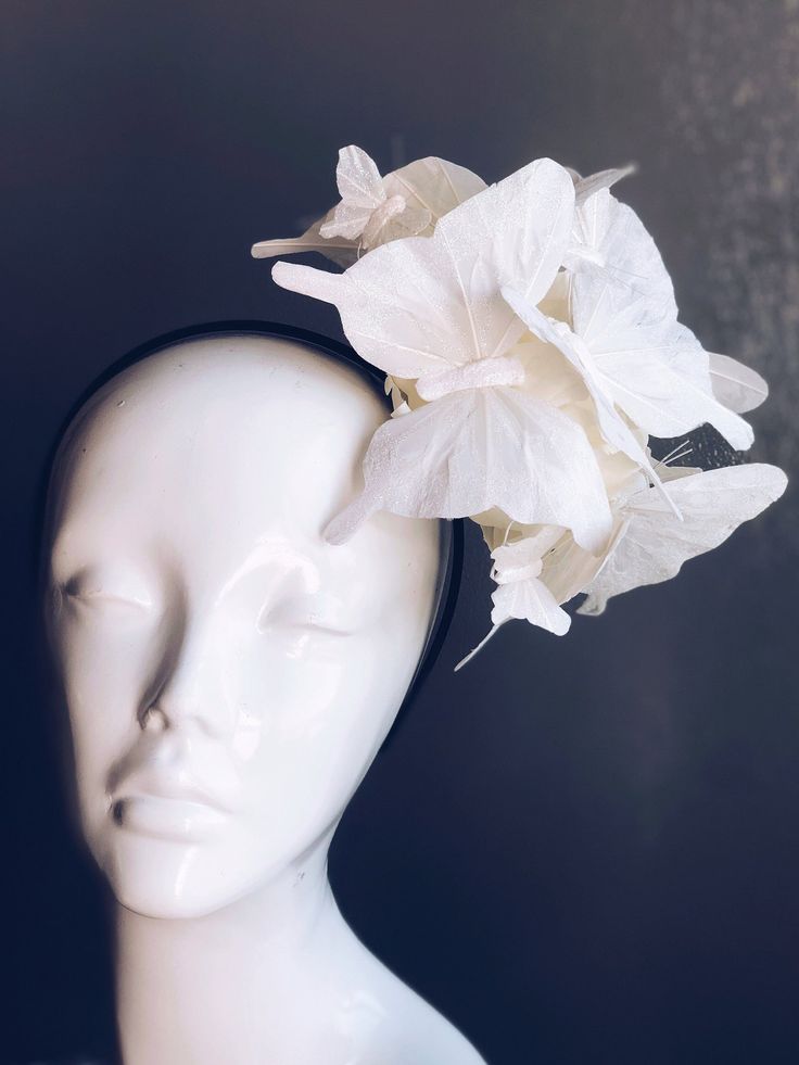 Inspired by the purity of white flowers and the enchanting flight of butterflies, our fascinator combines the two in a breathtaking display of whimsy and charm. Whether worn at weddings, garden parties, or races, it's sure to make a statement and leave a lasting impression. Age Group/Gender - Adult/Women Size/Type - One size fits all adults Color - White Special Features - White butterflies Personalization - Not available Butterfly Fascinator, Mardi Gras Kid, Kids Party Packs, White Butterflies, Female Mask, Flower Fascinator, Fascinator Hat, Garden Parties, Fascinator Hats