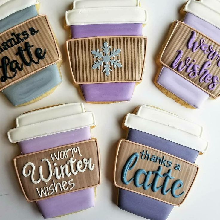 decorated cookies in the shape of coffee mugs with words on them and snowflakes