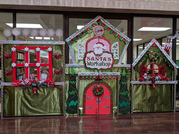 christmas decorations on display in front of windows