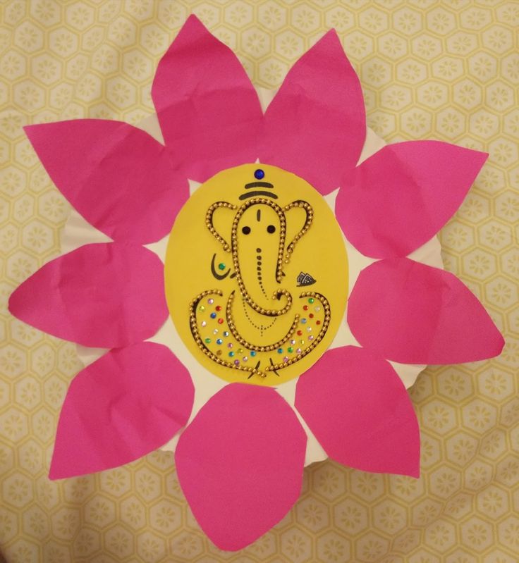 a paper flower with an image of the ganeshi idol on it's center