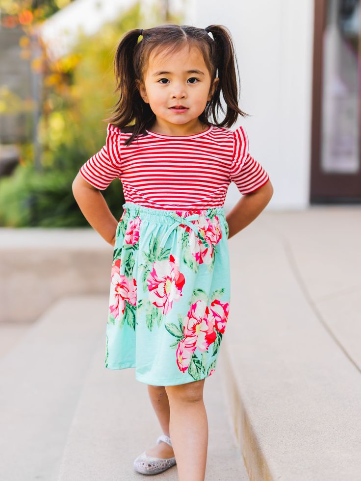 Upgrade your little one's closet with our Girls Stripe Floral Dress! Constructed with love and attention, this dress embodies charm and fashion. Your mini me will love the delightful designs and sweet cut of this dress.Sizing: SMALL - 3-4 yr MEDIUM - 4-5 yr LARGE - 6-7 yr XL - 8-9 yr Casual Flutter Sleeve Dress For Playdate, Spring Playwear Dresses With Flutter Sleeves, Playful Floral Print Playwear Dress, Playful Floral Print Dress For Playwear, Casual Flutter Sleeve Dresses For Playwear, Green Short Sleeve Playwear Dress, Floral Print Short Sleeve Playwear Dress, Red Floral Print Dress For Playtime, Cute Green Flutter Sleeve Dress