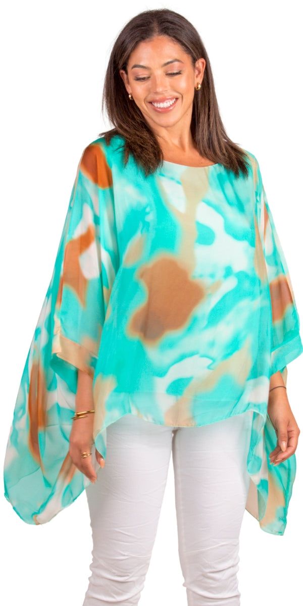 100% Silk Kaftan Style Blouse with Colorful Aura Print. Features 3/4 Length Sleeves and a Wavy Bottom. Exterior: 100% Silk Interior: 95% Viscose, 5% Elastic Fits Sizes XS- XL Made in Italy Multicolor Half Sleeve Tops For Beach, Green Half Sleeve Tops For The Beach, Bohemian Half Sleeve Blouse For Beach, Bohemian Half Sleeve Blouse For Vacation, Green Half Sleeve Tops For Vacation, Green Half-sleeve Top For Vacation, Green Half Sleeve Top For Vacation, Bohemian Half Sleeve Beach Blouse, Multicolor Half Sleeve Blouse For Summer