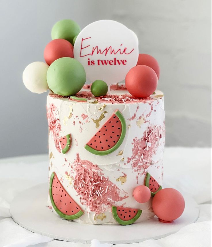 a cake decorated with watermelon and pink icing