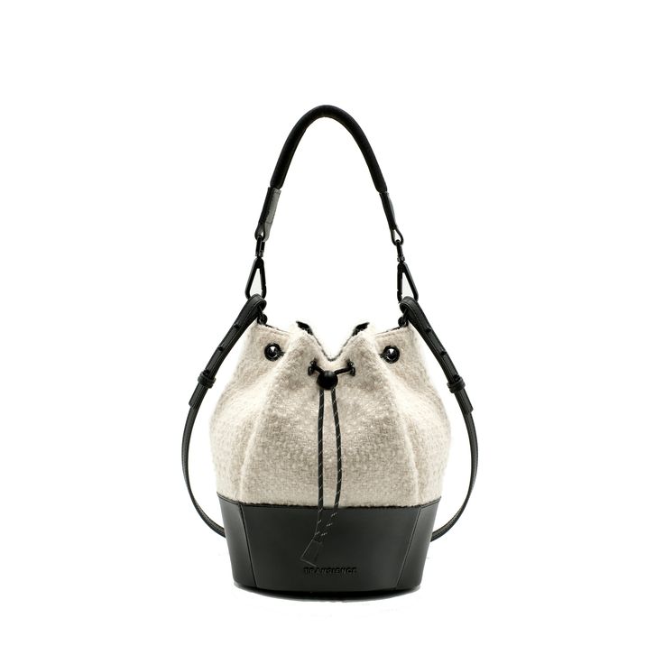 THIS STYLE IS PRE-ORDER: SHIP WINDOW JAN 1 - 30 Boucle crossbody bucket bag with structured leather base, comes with padded webbing top strap & adjustable leather crossbody strap. DetailsLightweight nylon & leather bucket bag, with adjustable shoulder to crossbody top strap. Features- Water resistant outer & lining- Drawstring Closure- Adjustable leather shoulder to cross-body strap- Interior zip pocket- key clip lanyardDimensionsW 8 " x H 10 " x D 8" Adjustable Crossbody Strap Mater Leather Trim Bucket Shoulder Bag For On-the-go, Functional Satchel Bucket Bag With Adjustable Strap, Functional Bucket Bag With Adjustable Strap In Satchel Shape, Modern Bucket Shoulder Bag With Leather Trim, Leather Bucket Bag With Leather Trim For On-the-go, Modern Crossbody Bucket Bag With Leather Trim, Casual Bucket Bag In Coated Canvas, Functional Bucket Shoulder Bag With Adjustable Strap, Modern Leather Trim Bucket Shoulder Bag