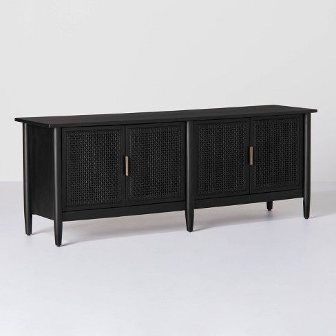 the sideboard is black and has two doors on each side, with gold handles