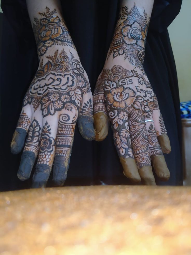 the hands are decorated with henna designs