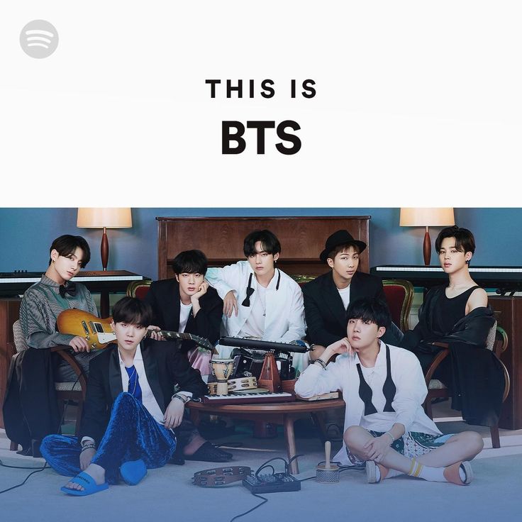 this is bts poster with four men sitting on the floor and one man holding a guitar