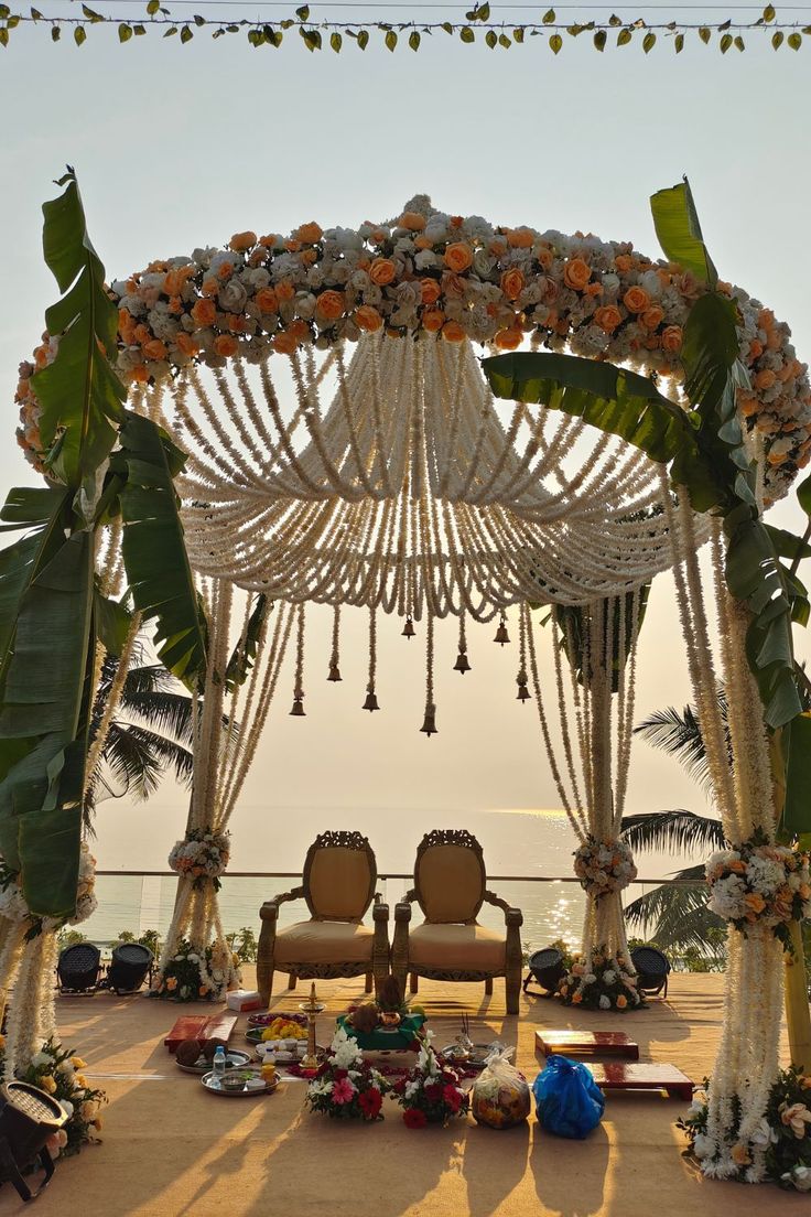 an outdoor wedding setup with chairs and flowers