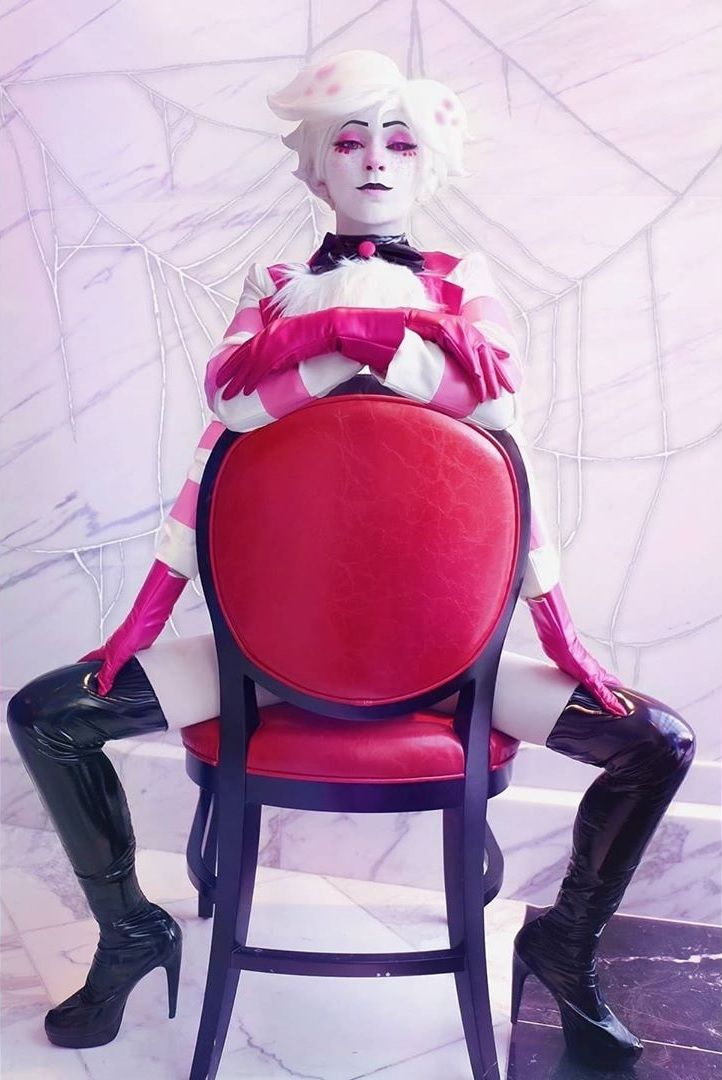 a woman sitting on top of a red chair