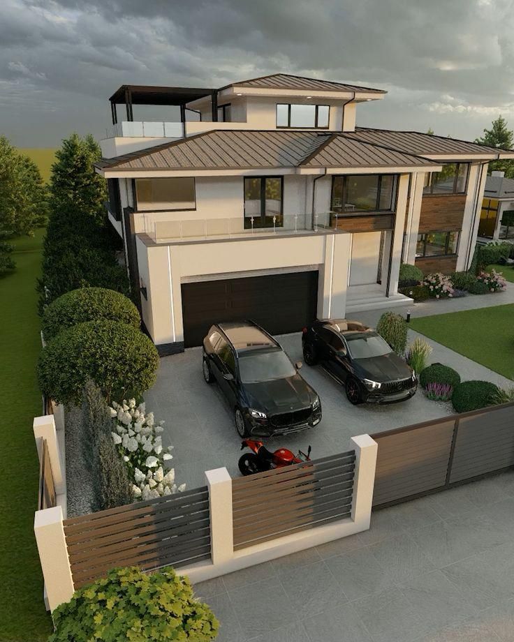 two cars are parked in front of a house with a fence and landscaping around it