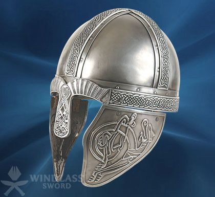 a silver helmet with an intricate design on the front and side, against a blue background