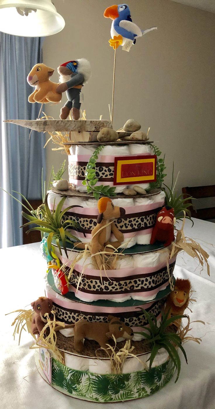 a multi layer cake with stuffed animals on top