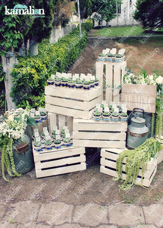 several wooden pallets with flowers and vases in them sitting on the ground next to each other