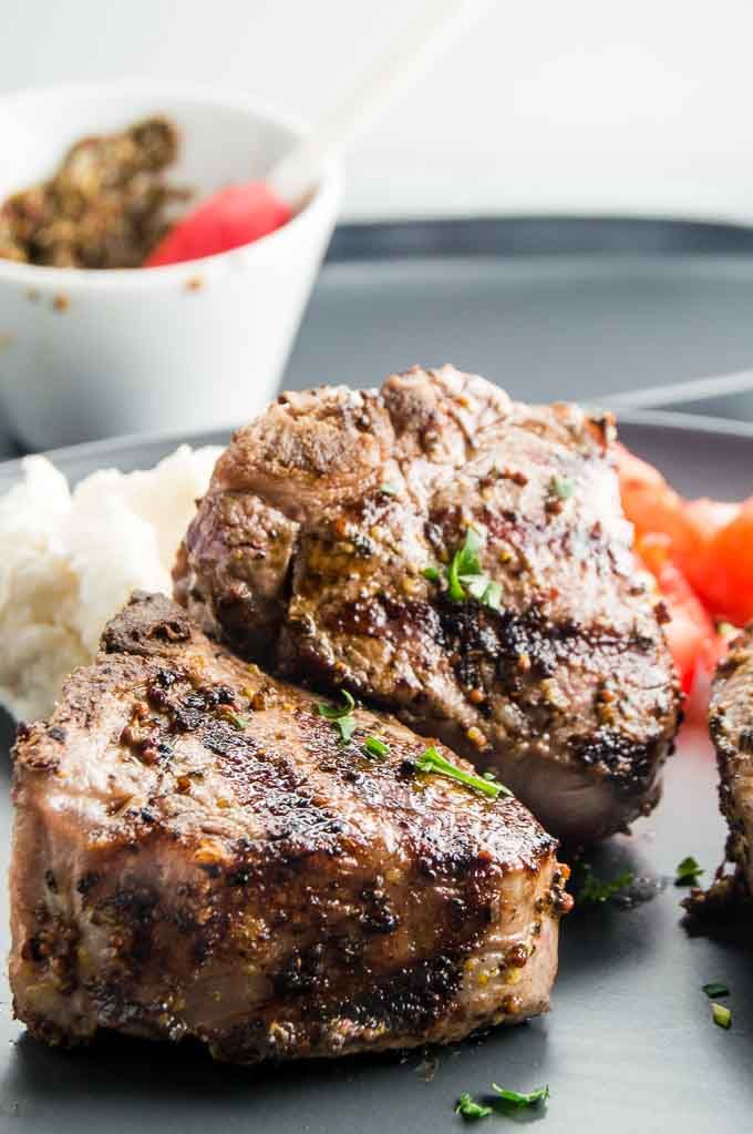 greek lamb chops on a plate with mashed potatoes