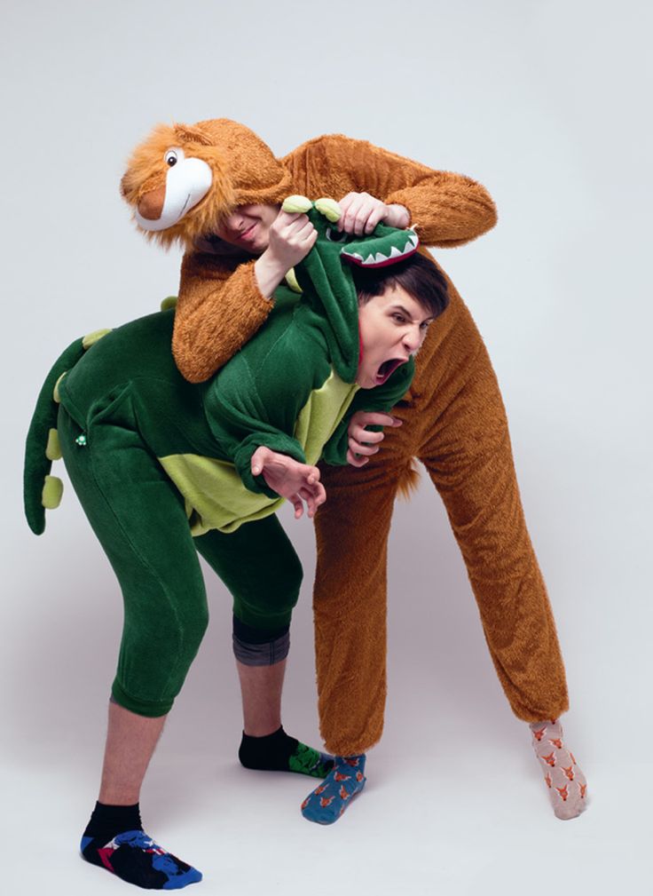 two people dressed in animal costumes, one is holding a stuffed monkey on his head