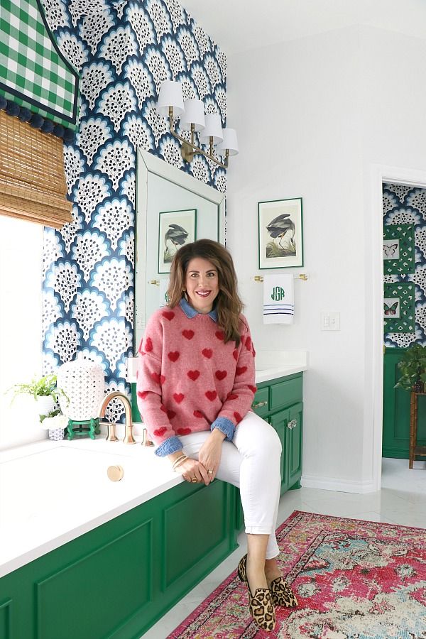 a woman sitting on the edge of a bath tub